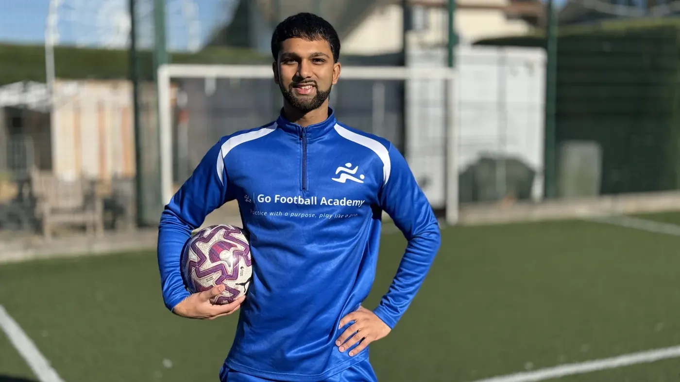 Coach Farhan in Go Football Academy kit holding a football
