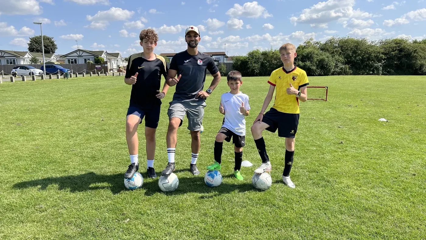 Players and coach on the bootcamp pitch
